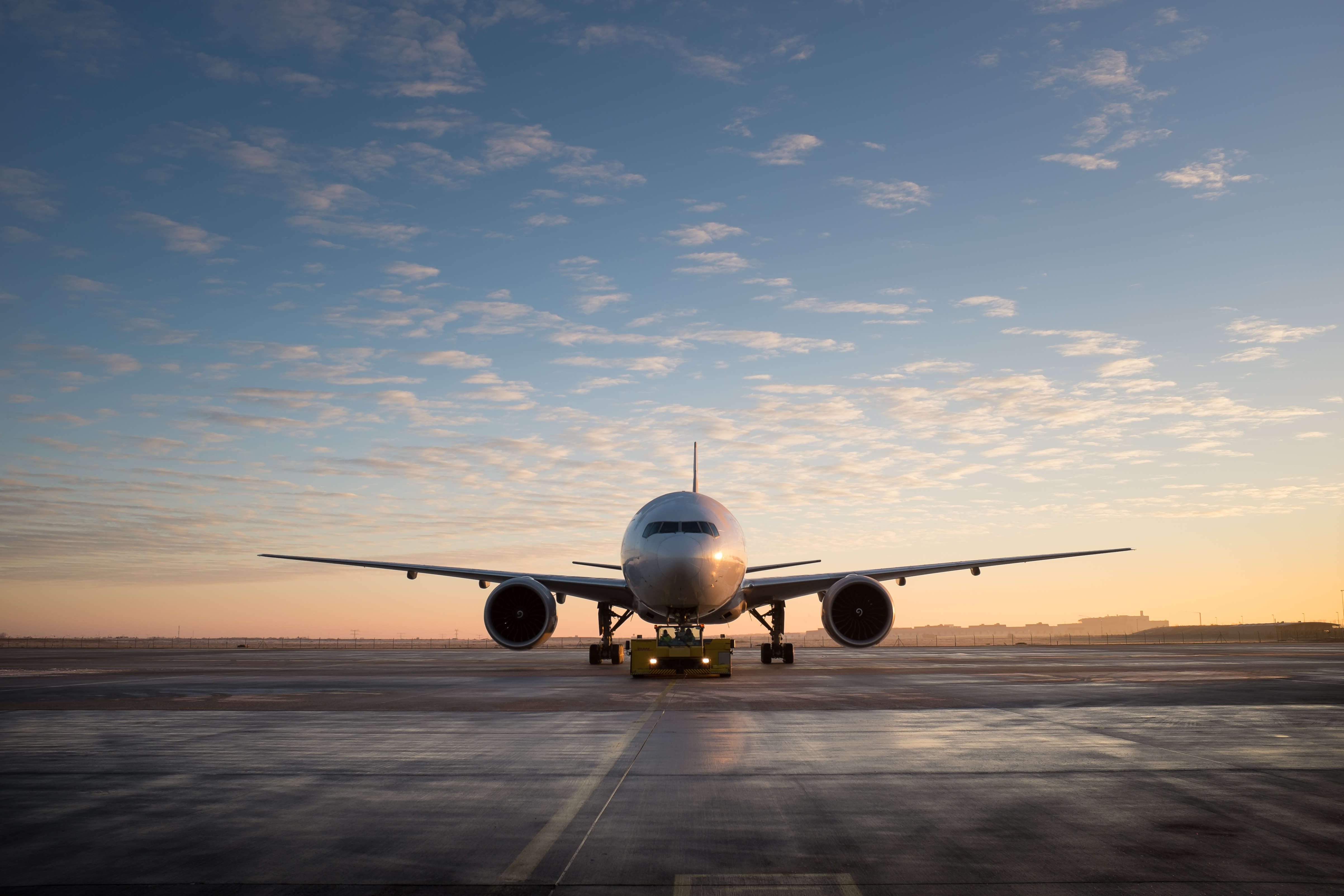 airplane-runway-against-sky-sunset